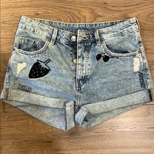 Denim shorts with graphic prints